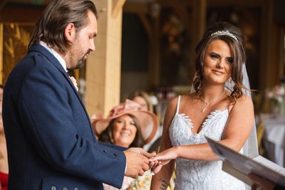 candid moment with couple exchanging rings