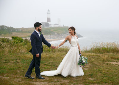 Bride and groom walking at  Camp Hero Montauk Lighthouse. 360 East Montauk Downs