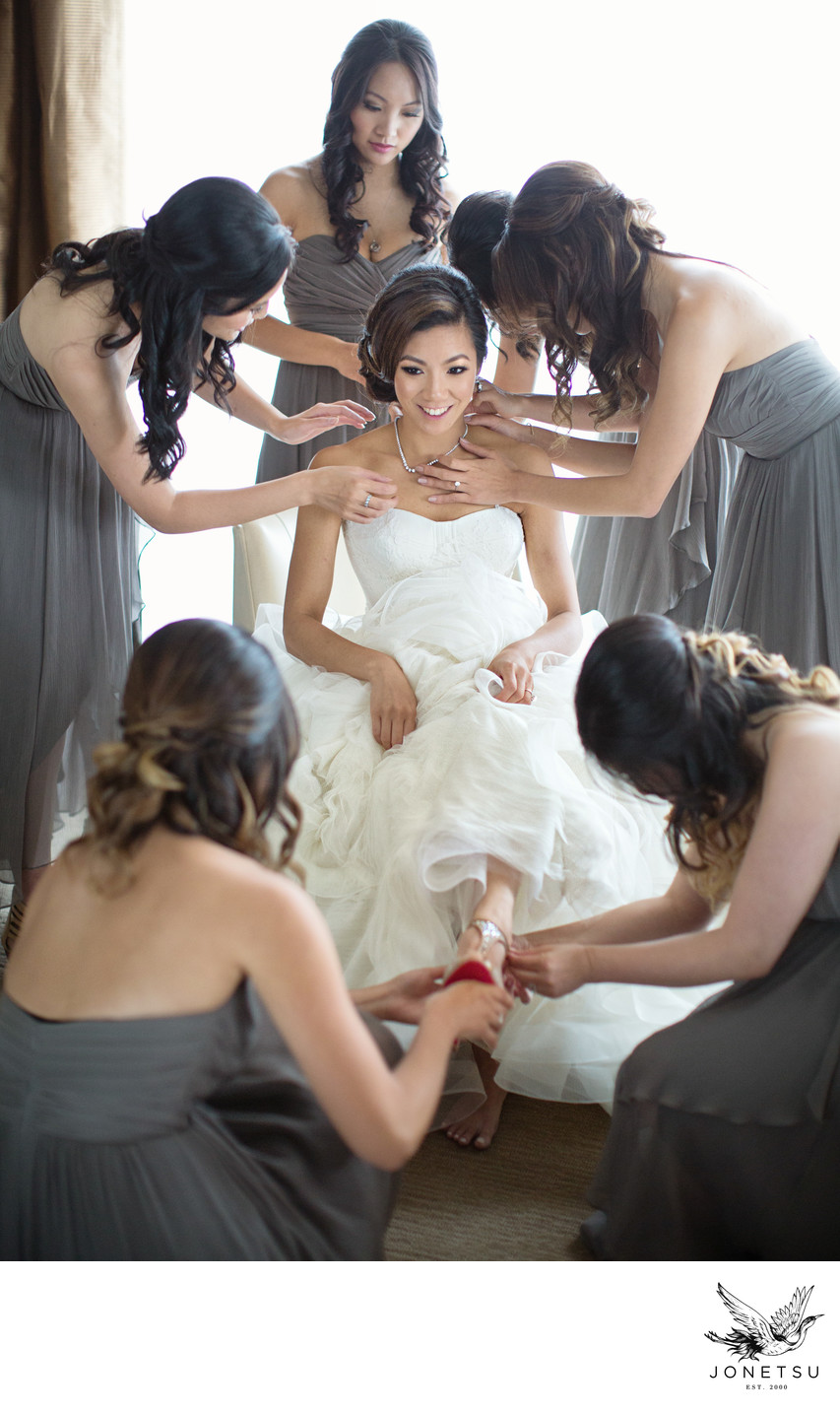 Vancouver bridesmaids in gowns help bride in Vera Wang