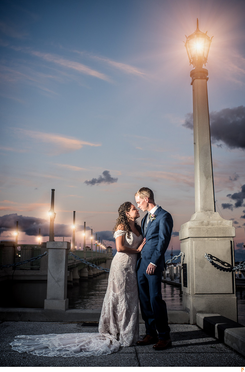 Bride and groom on the Bridge of Lions at sunset in st Augustine