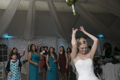 Bride throwing her bouquet.  Dinuba Wedding 