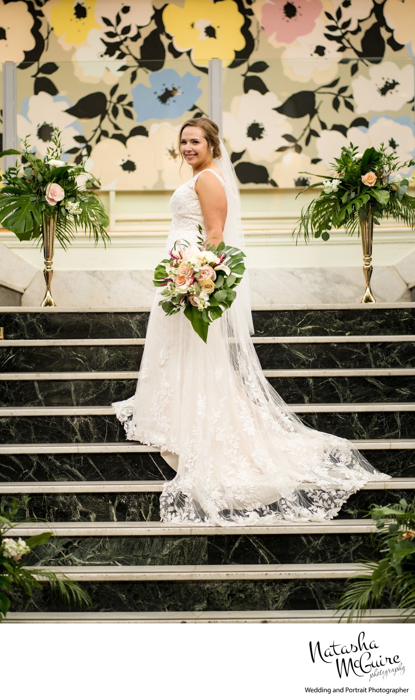 Bride on staircase at Majorette with Leshers Bouquet