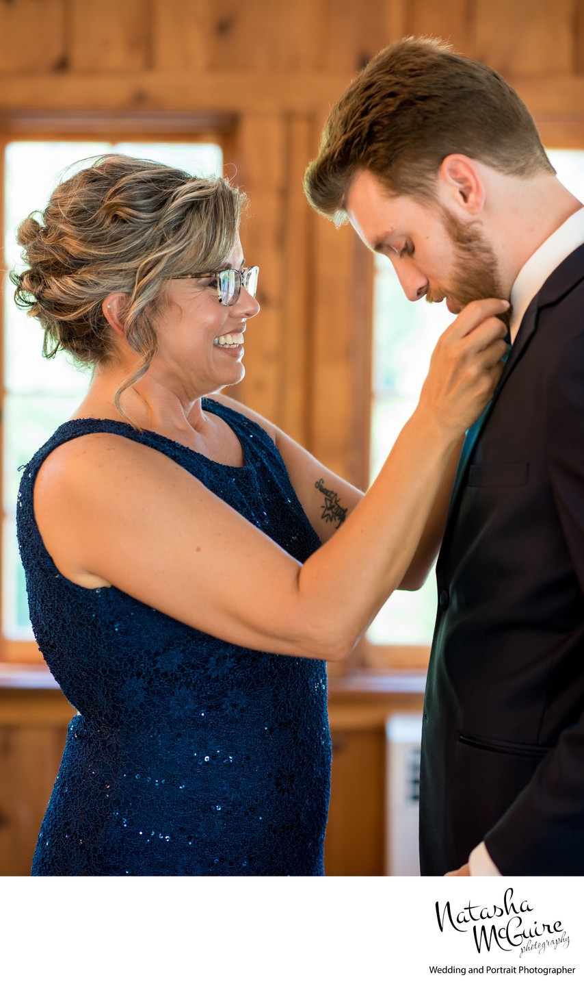 Mother helping son before wedding ceremony St Louis