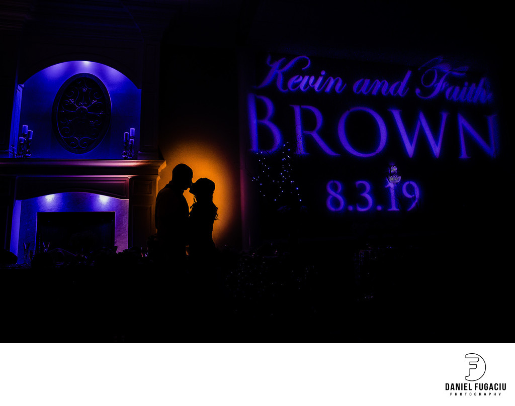 Silhouette of bride and groom in reception room