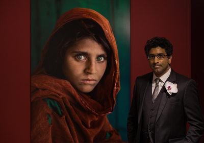 Grooms portrait next to famous portrait Afghan Girl