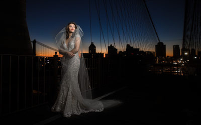 Brooklyn Bridge bride with veil in the wind at sunrise