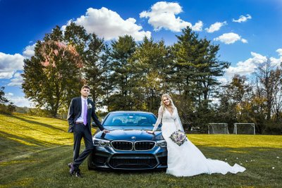 Wedding couple posing with BMW M5