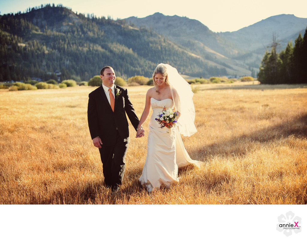 newlyweds stroll in Squaw Valley meadow in fall