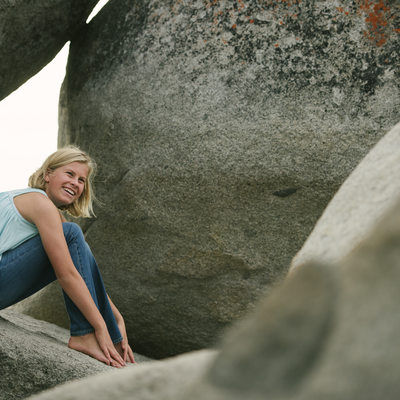 Teen on boulders in Lake Tahoe