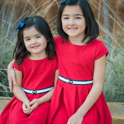 Cute siblings in red dresses