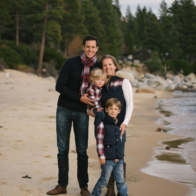 Family in plaid on beach in Lake Tahoe
