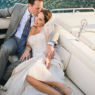 Bride and groom getting comfy in boat at West Shore 