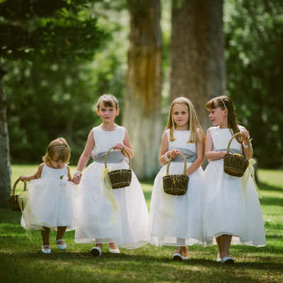 flower girls walking on lawn to ceremony