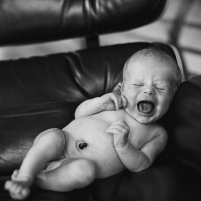 Newborn crying in mid century chair