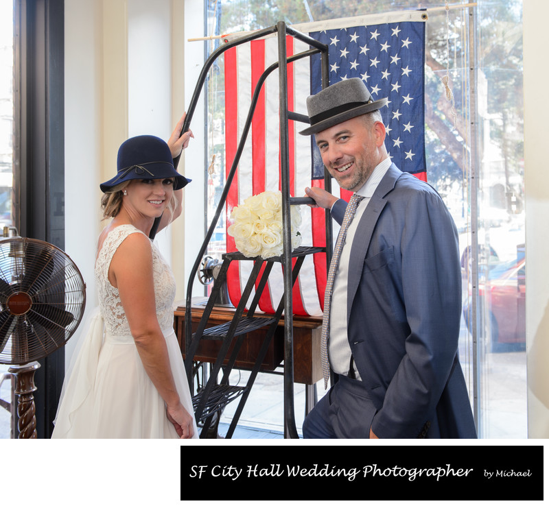 Window photo of Bride and Groom at North Beach Hat Shop