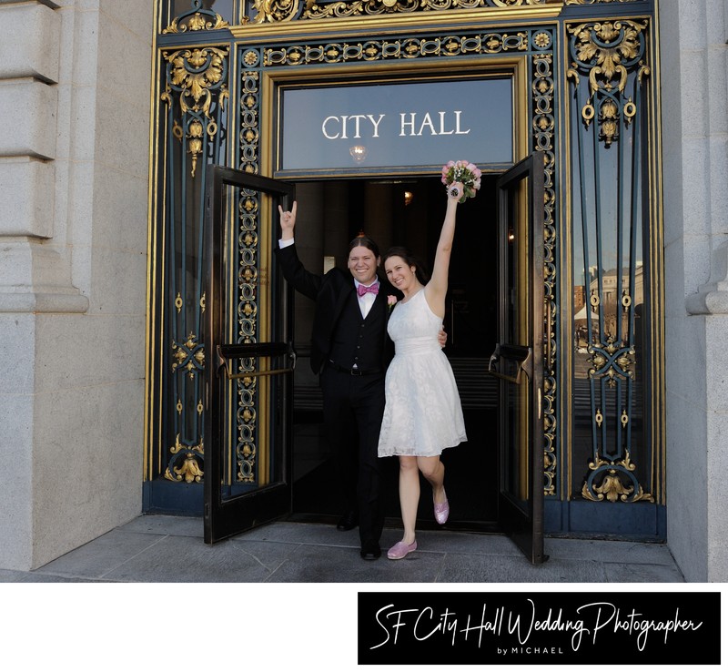 Happy newlyweds leaving San Francisco city hall after nuptials complete