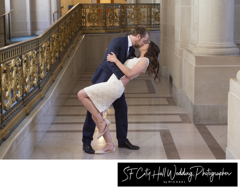 City hall Wedding Kiss at the gold railing