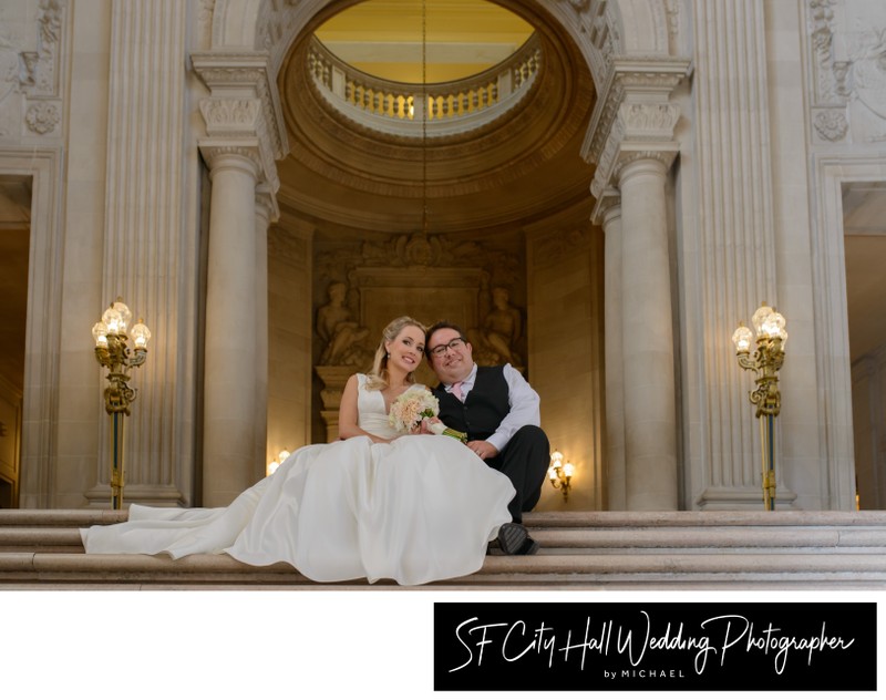 Newlyweds sitting on Grand Staircase by the Rotunda