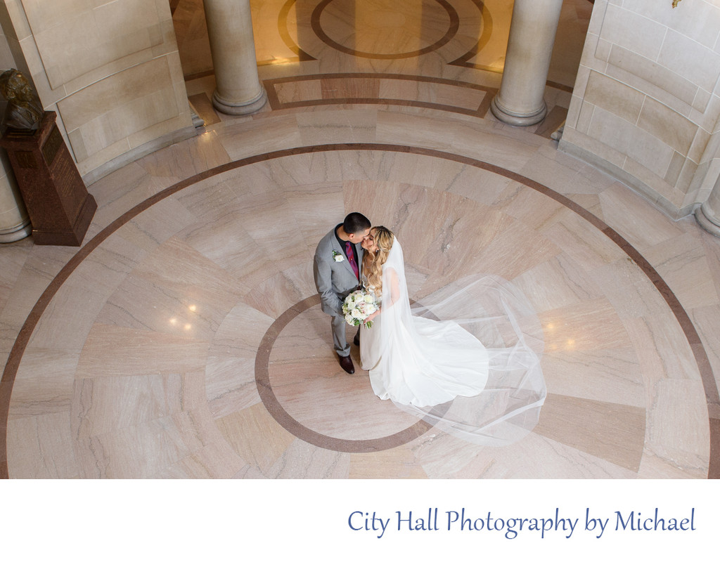 Newlywed Bride and Groom kissing at Rotunda in City Hall