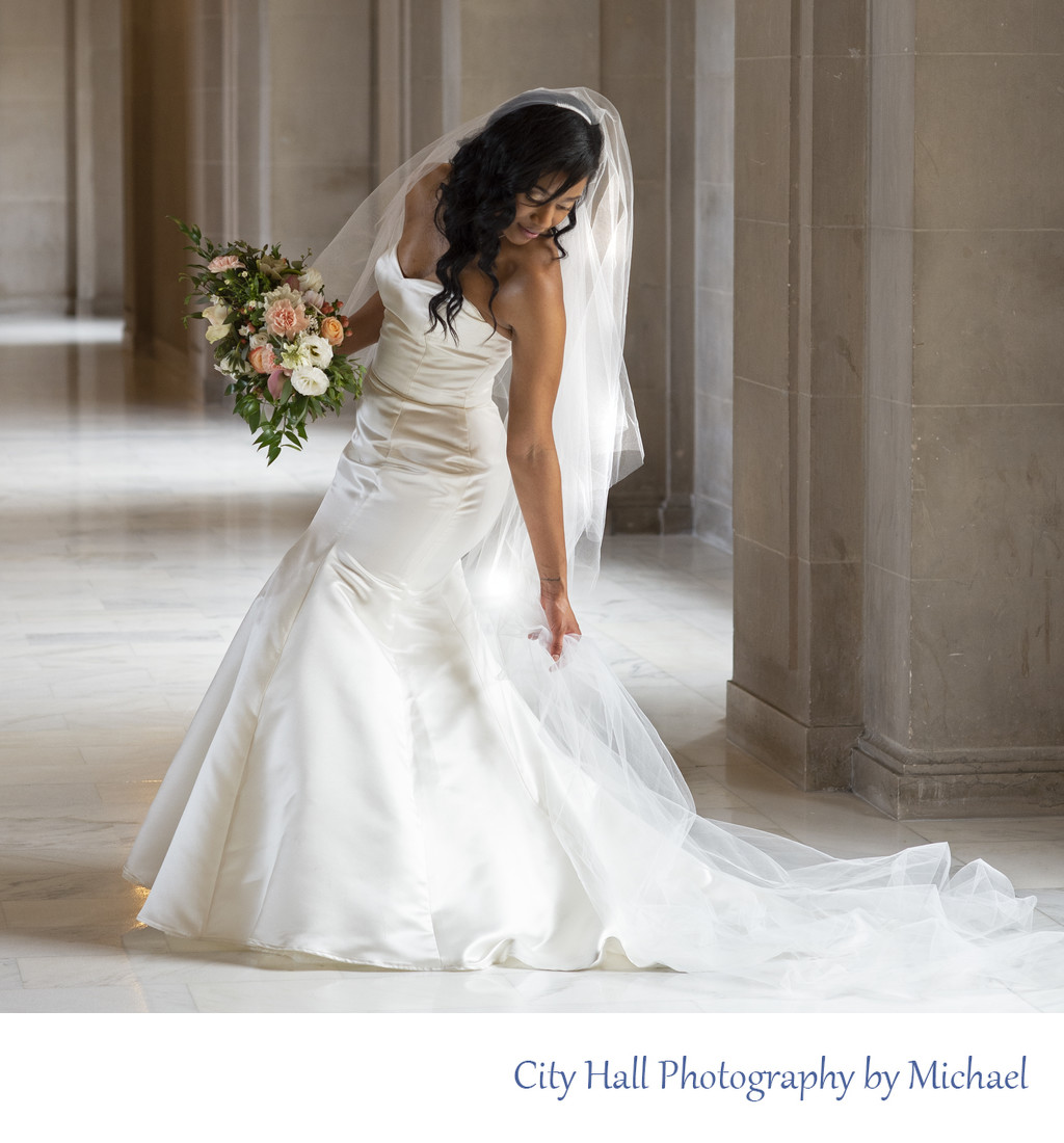 City Hall Bride Adjusting Dress during Wedding Photos
