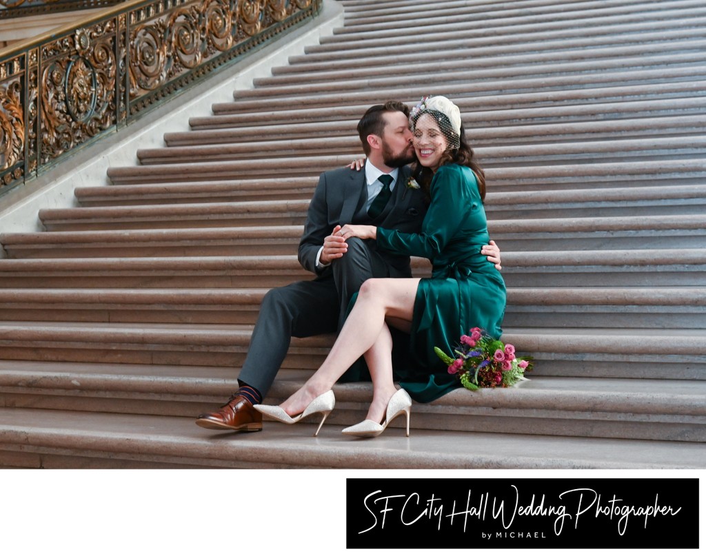 Bride and Groom sitting on the Staircase at San Francisco city hall