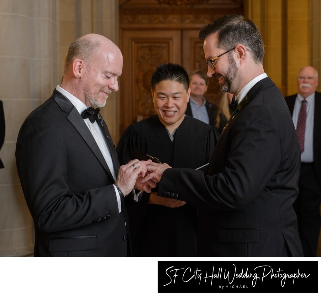 Gay grooms exchanging rings at San Francisco city hall