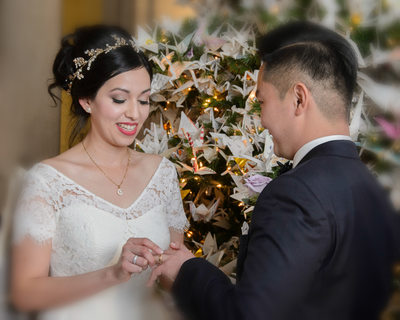 Bride and Groom Exchanging Rings during their Christmas Nuptials