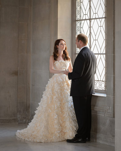Bride and groom in natural light at a City Hall window