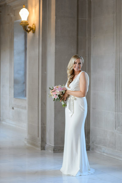 Blonde bridal portrait with bouquet at city hall