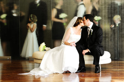 Best wedding photograph of bride and groom with little girl kissing at 7° Degrees art museum in Laguna Beach California