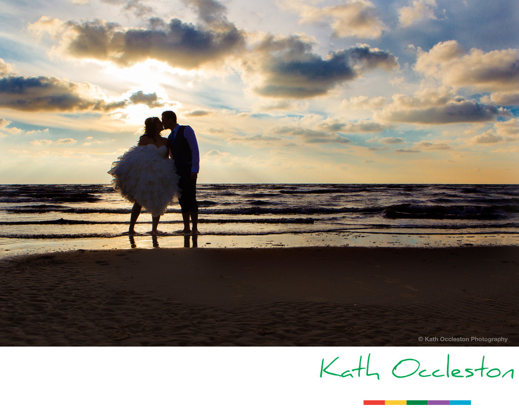 Silhouette of bride and groom on the beach