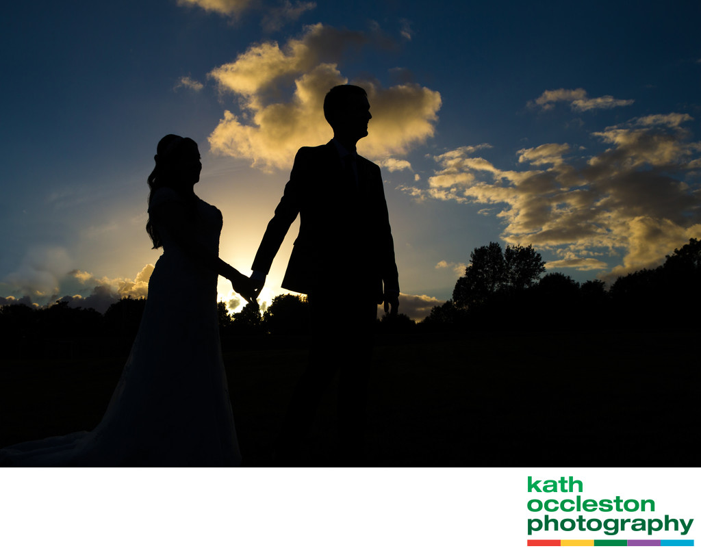 Silhouette of bride and groom In the sunset