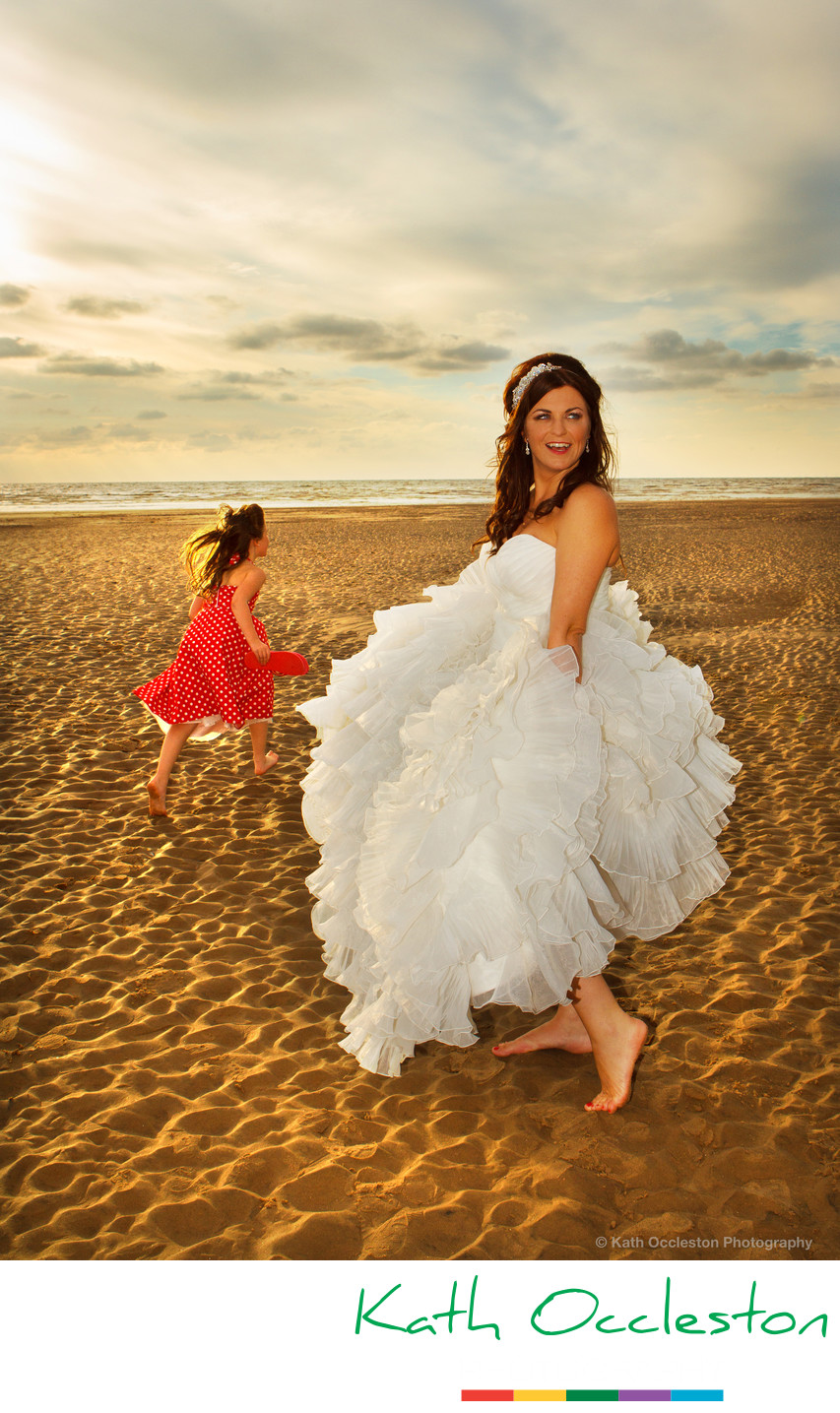 Bride and flowergirl on the beach