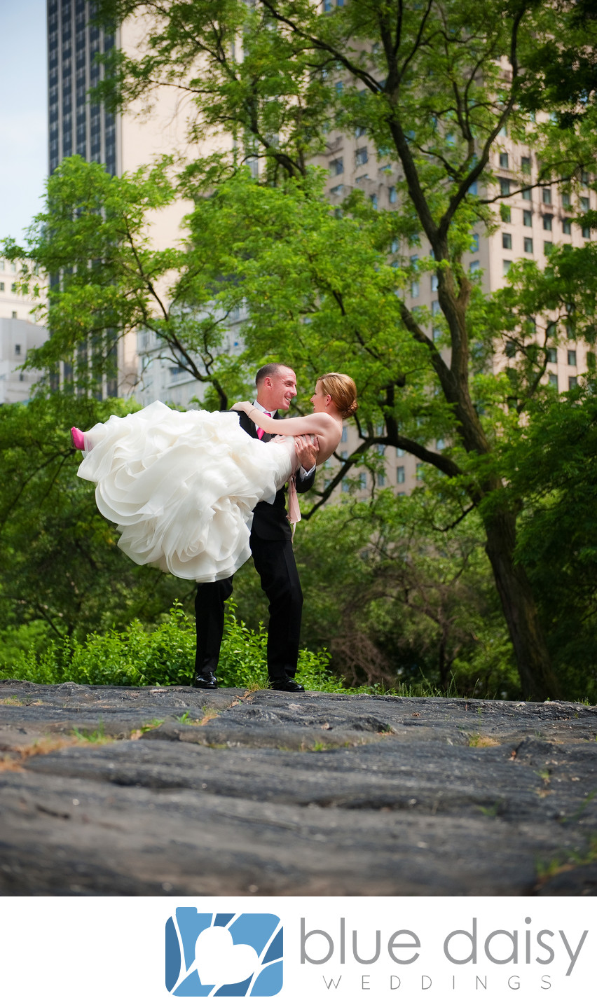 Bride groom standing on rock in Central Park NYC