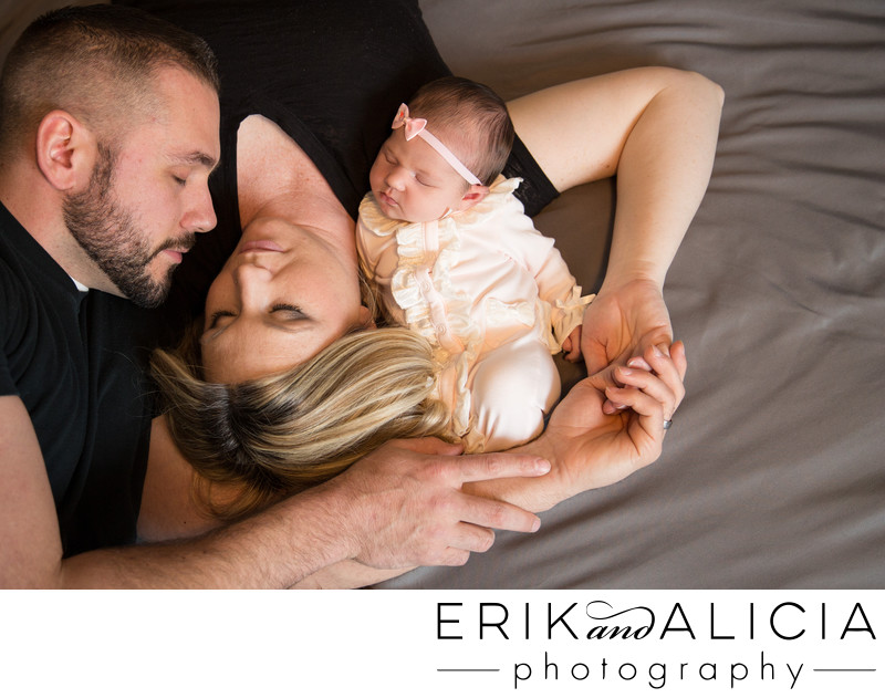 newborn-baby-mommy-daddy creative pose on bed newborn-baby-mommy-daddy creative pose on bed