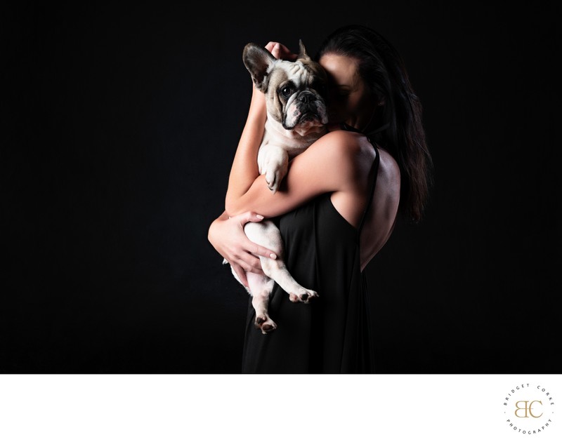 Elegant Portrait of Woman Hugging French Bulldog Elegant Portrait of Woman Hugging French Bulldog