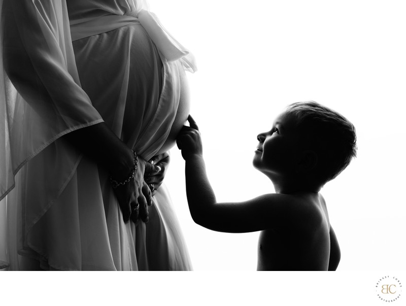 Silhouette of Child Touching Baby Bump Silhouette of Child Touching Baby Bump