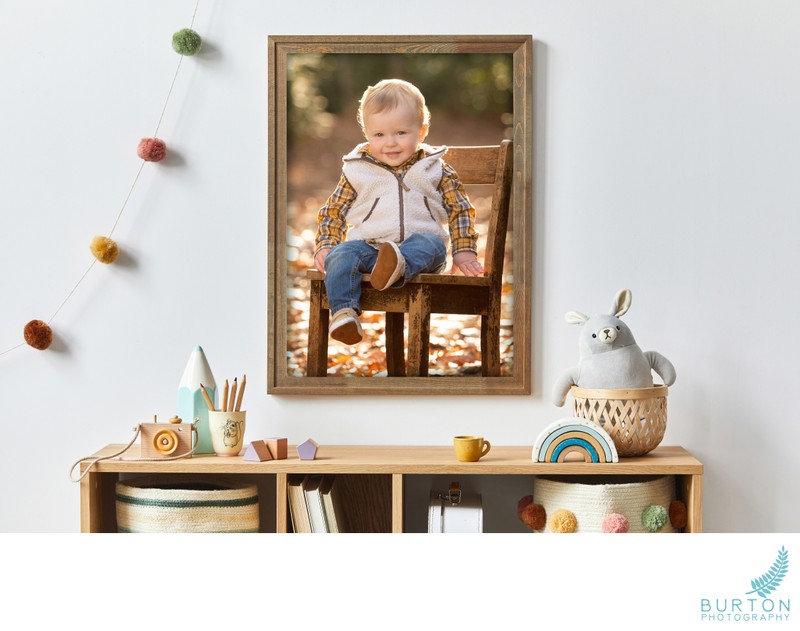 Stylish scandinavian newborn baby room with brown wooden mock up poster frame, toys, plush animal and child accessories. Cozy decoration and hanging cotton flags on the white wall. Template. Stylish scandinavian newborn baby room with brown wooden mock up poster frame, toys, plush animal and child accessories. Cozy decoration and hanging cotton flags on the white wall. Template.