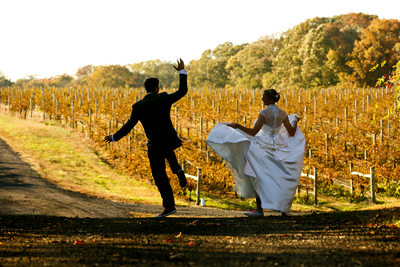The bride word St. Pucchi and converse as she and her groom ran through the vineyard. 