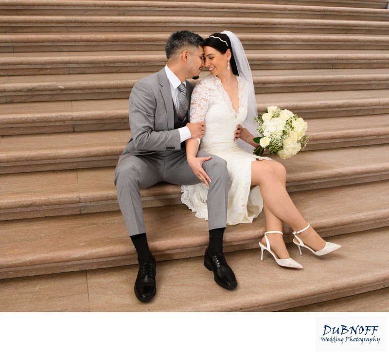 Bride and Groom sitting on SF City Hall Grand Staircase