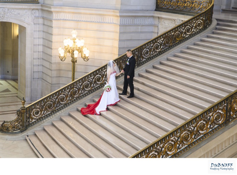 SF City Hall Bride and Groom posing on the Grand Staircase