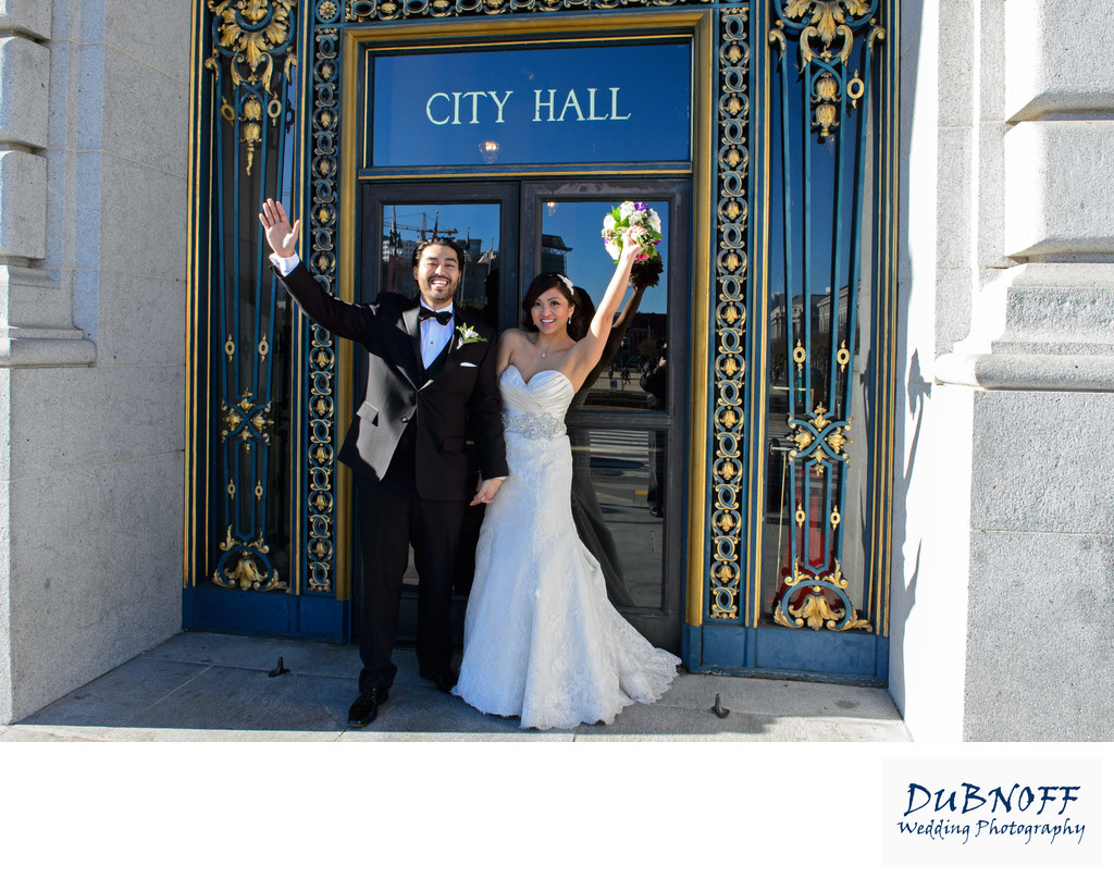 City Hall Sign  Bride and Groom Waving to photographer