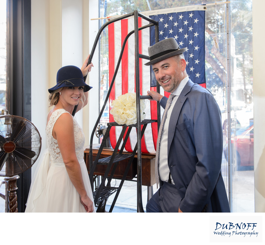 Bride and Groom having fun at the North Beach Hat Shop