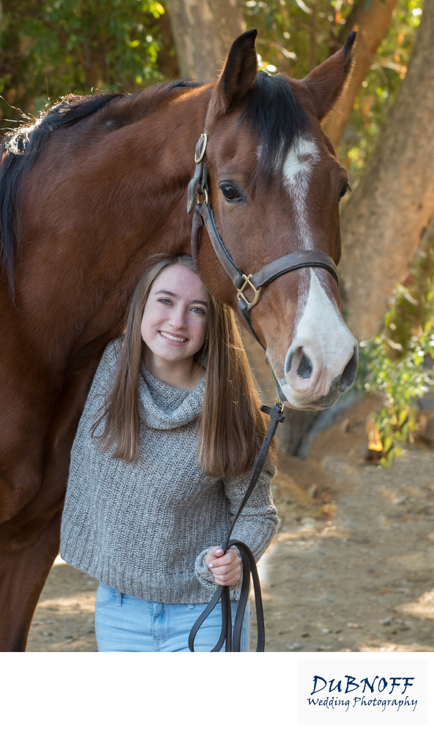Girl Posing Under Horse during High School Senior Portrait Session