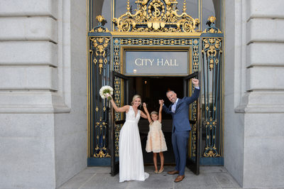 Woo Hoo!  Couple leaving San Francisco city hall with daughter