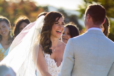 Bride Laughing during wedding vows.  San Francisco Bay Area Photography