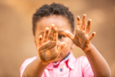 Little boy with mud, Louis G Weiner Photography