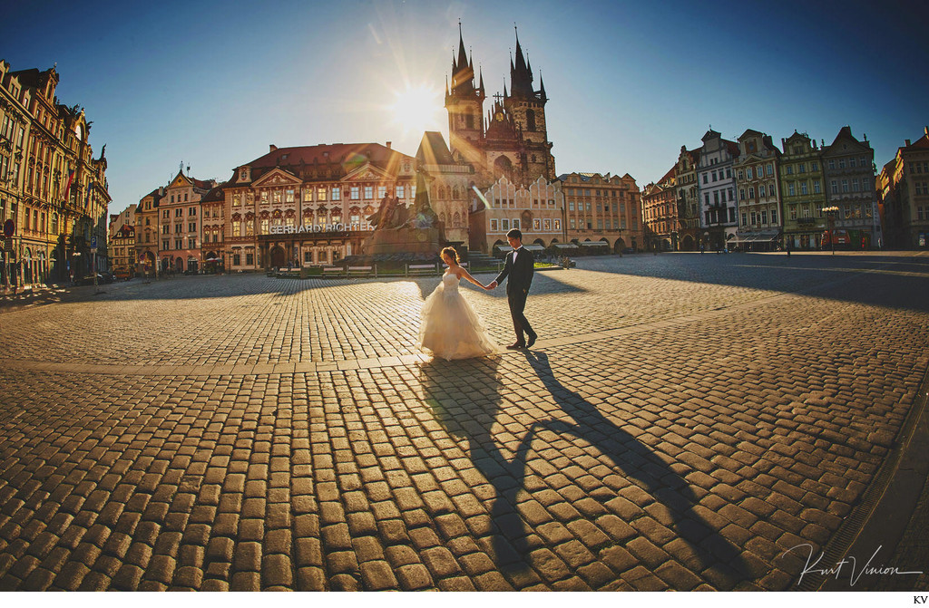 walking hand in hand at sunrise Old Town Square Prague