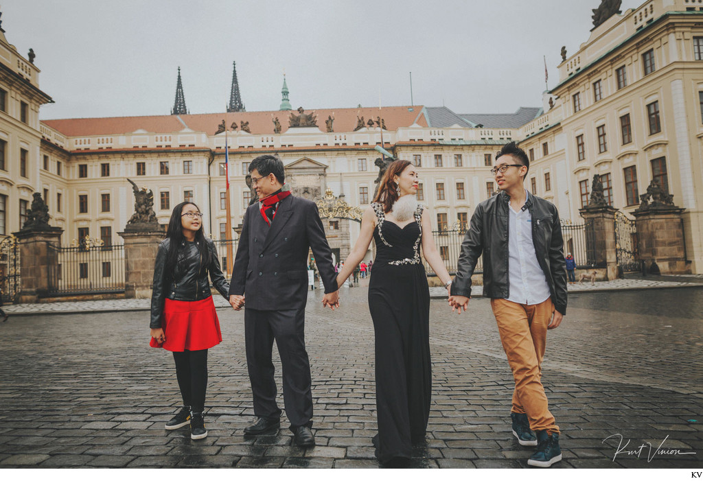family walking hand in hand Prague Castle
