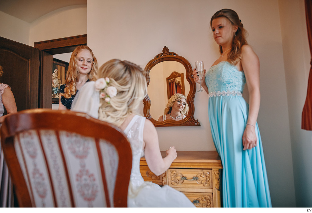 bride checks herself in mirror Castle Hluboka weddings